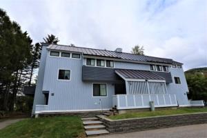 a white house with a solarium on top of it at Sunnyside 6 in Condo Waterville Valley in Waterville Valley