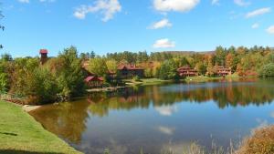 a large lake in front of a house at Deer Park Condo 165D Vacation Rental near Loon Mountain in Woodstock