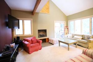 a living room with a couch and chairs and a tv at Forest Rim I1 WV Pet Friendly Ski Vacation Condo in Waterville Valley in Waterville Valley