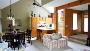 a kitchen and living room with a table and a couch at Forest Rim I1 WV Pet Friendly Ski Vacation Condo in Waterville Valley in Waterville Valley