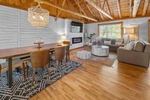 a living room with a table and a couch at Serenity - 60 Ridge Lane in Branson