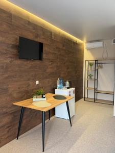 a room with a table and a tv on a wall at Villa HOLM in Solotvyno +12 photos