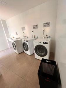 two washing machines and a washer and dryer in a room at Solon Flat Manaira in João Pessoa