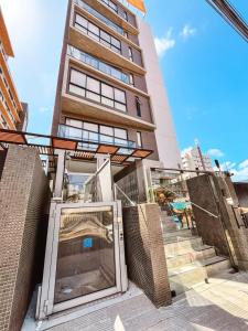 a building with a revolving door in front of it at Solon Flat Manaira in João Pessoa