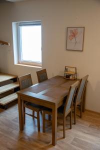 a dining room with a wooden table and chairs at Apartmán Cukrárna in Mladá Vožice +6 photos