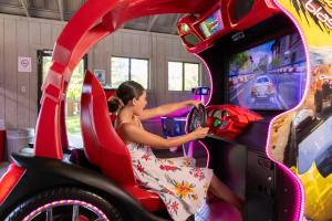 a woman playing a video game in a game machine at Serenity - 60 Ridge Lane in Branson +104 photos