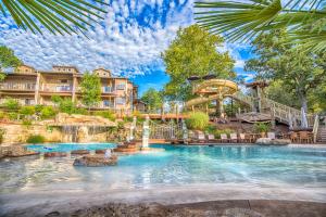 a pool in a resort with a water slide at Serenity - 60 Ridge Lane in Branson
