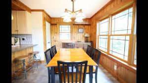 a kitchen with a wooden table and chairs at Welch View 68 Thornton Deluxe Private 4 Bedroom Home in Thornton