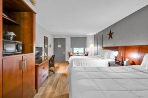 a hotel room with two beds and a tv at Harvest Drive Family Inn - Renovated Rooms in Gordonville