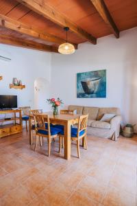 a living room with a table and chairs and a couch at Son Flor Agroturisme in Santa Margalida