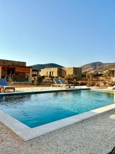 a swimming pool in front of a house at Ampelonas Antiparos in Antiparos
