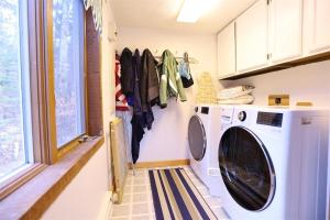 a laundry room with a washing machine and a window at Goose Hollow 19 Estates Pet Friendly Private Waterfront Home in Campton