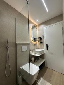 a bathroom with a shower and a toilet and a sink at Villa Ani in Borsh +114 photos