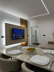 a dining room with a table with plates and fruit on it at Villa Ani in Borsh