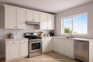 a white kitchen with white cabinets and a window at Westgate Bimini Bay in Bailey Town