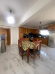 a kitchen with a table and chairs in a room at Las Tres Casitas in San Felipe de Puerto Plata