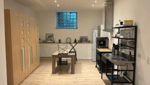 a kitchen with a table and a sink and a counter at Feinlötstube in Alzenau