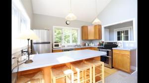 a kitchen with a large white island in a kitchen at Weetamoo Trail 50 Estates Relax in the White Mountains in Campton