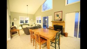 a dining room with a table and a living room at Weetamoo Trail 50 Estates Relax in the White Mountains in Campton