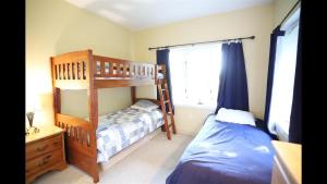 a bedroom with two bunk beds and a bed at Weetamoo Trail 50 Estates Relax in the White Mountains in Campton