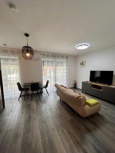a living room with a couch and a table at iHome Apartman 4 in Pécs
