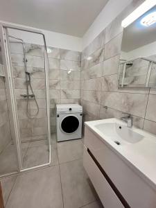 a bathroom with a shower and a toilet and a sink at iHome Apartman 4 in Pécs +5 photos