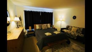 a bedroom with a bed and a couch at Windsor Hill E53 WV Updated Pet Friendly Windsor Hill Condo in Waterville Valley +8 photos
