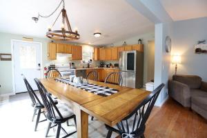 a kitchen and dining room with a wooden table and chairs at Bog Road 76 Campton Cozy Private Single Family Home in Campton in Campton