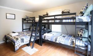a bedroom with two bunk beds and a bed at Bog Road 76 Campton Cozy Private Single Family Home in Campton in Campton