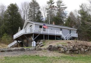a house on a hill with an american flag on it at Bog Road 76 Campton Cozy Private Single Family Home in Campton in Campton