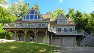 a large house with a porch and a deck at Welch View 41 Thornton Private Home Close to Waterville Valley in Thornton