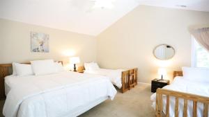 a bedroom with two beds and a mirror at Rising Ridge 28 Owls Nest Deluxe Pet friendly Home at Owl`s Nest in Campton