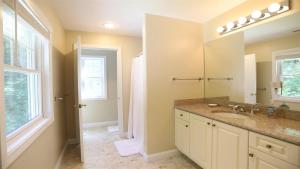 a bathroom with a sink and a mirror at Rising Ridge 28 Owls Nest Deluxe Pet friendly Home at Owl`s Nest in Campton +6 photos