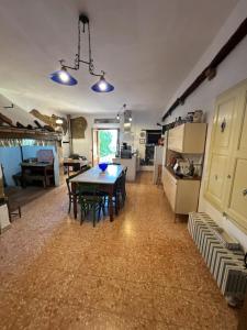 a kitchen with a table in the middle of a room at La Nobiltà del Tempo in Murlo +18 photos