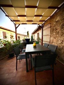 a wooden table and chairs on a patio at La Nobiltà del Tempo in Murlo