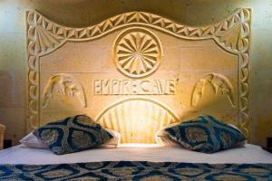 a wooden headboard with two pillows on a bed at Empire Cave Cappadocia in Göreme