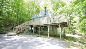 a large house with a deck on top of it at Green Circle 29 Estates Pet Friendly Private Home in Waterville Estates in Campton