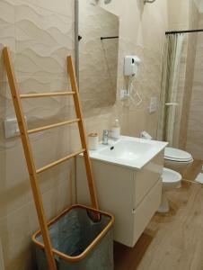 a bathroom with a toilet and a sink and a ladder at Le Suite di Antonella in Taranto +12 photos