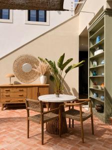 a table and chairs in a room with a staircase at A Casa Brava in Santarém