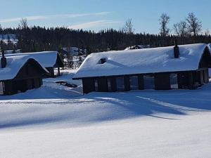 an old barn with snow on the roof at 4 star holiday home in Øyer in Øyer