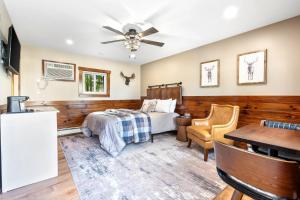 a bedroom with a bed and a table at The Inn at the Rostay in Bethel