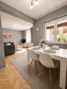 a living room with a white table and chairs at Green Paradise in Vrnjačka Banja