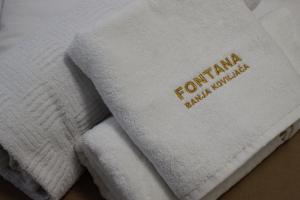 a pile of towels sitting on top of a table at Apartmani Fontana Banja Koviljaca in Banja Koviljača