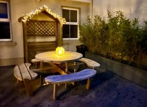 a table and benches with a light on a patio at Fairy Fort View, Lahinch in Carrowauff