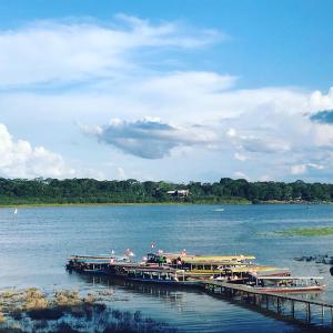two boats are docked at a dock on a lake at Hotel Roman in Pucallpa
