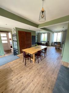 a large room with a wooden table and chairs at Le Kompost'l dortoir en gîte 4 place in Saint-Privat-dʼAllier