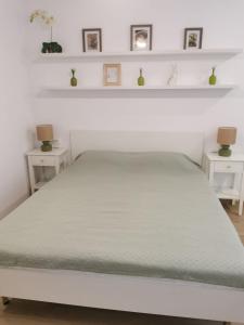 a bedroom with a white bed with two side tables at Happy Home1 in Cahul