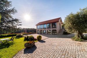 a large brick building with a table and chairs at RioVerde Agroturismo in Barcelos