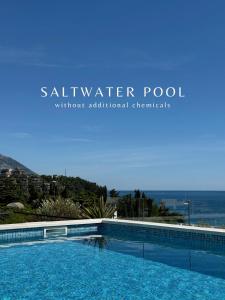 a swimming pool with the ocean in the background at Luminoso Boutique Hotel in Budva