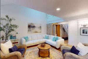 a living room with a white couch and blue pillows at 103 Ruffed Grouse Ct in Lake Harmony